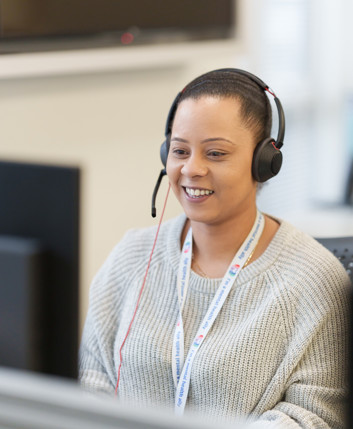 A woman with a headset in an office